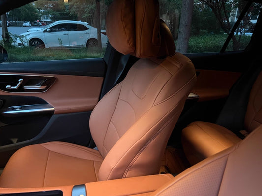 Close-up side view of brown artificial Nappa leather front seat cover in Mercedes Benz W205