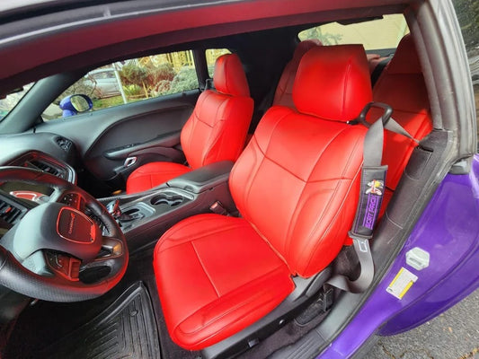 Bright red artificial nappa leather seat covers perfectly fitted inside a Dodge Challenger 2021 showing front and rear seating