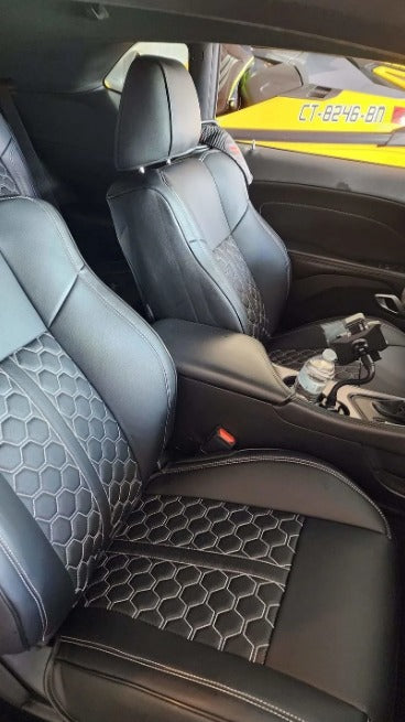 Interior view of 2021 Dodge Challenger front seats with black artificial Nappa leather seat covers featuring white hexagon pattern stitching