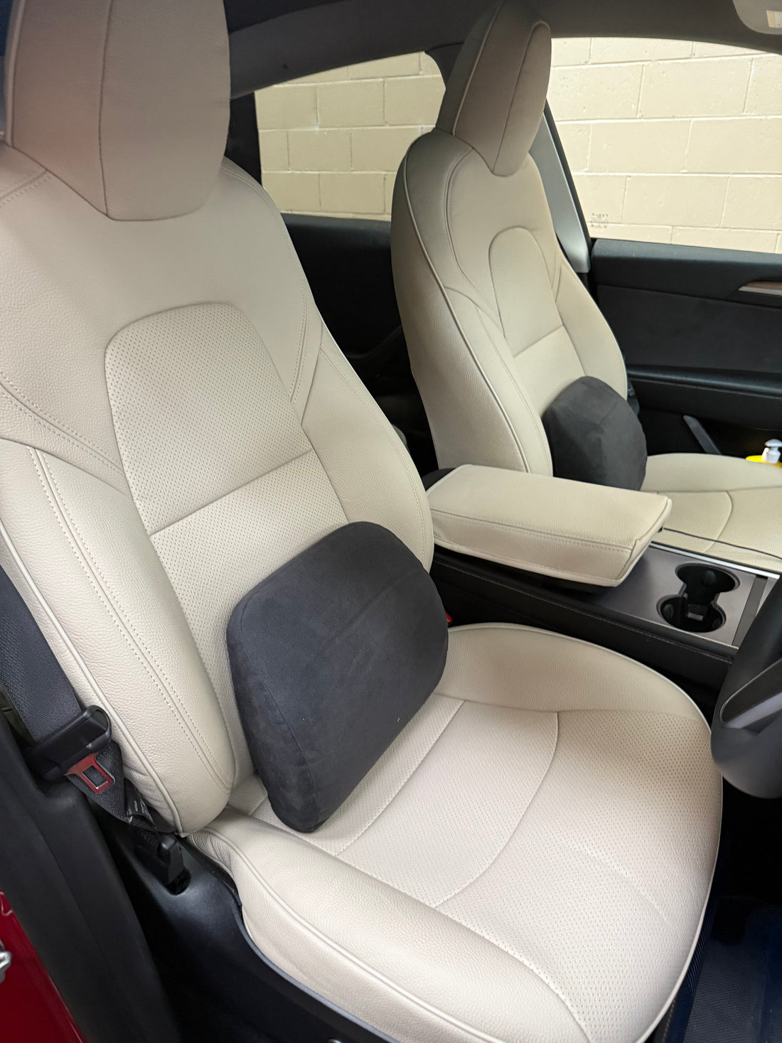 Close-up of custom fit beige Italian cowhide leather seat covers on Tesla Model Y front seats