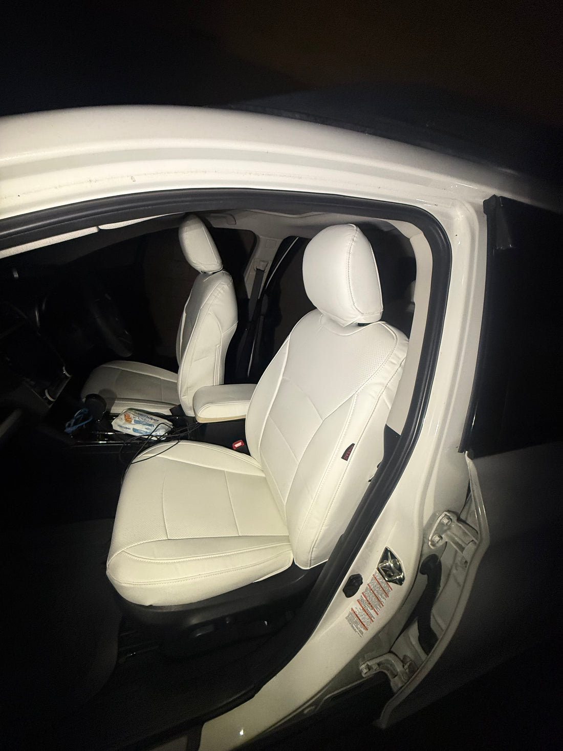 Front seats of 2018 Subaru Outback with white leather custom-fit seat covers