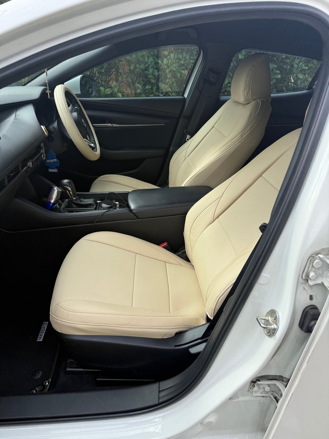 Close-up side view of custom-fit beige artificial nappa leather seat cover on Mazda 3 hatchback front passenger seat