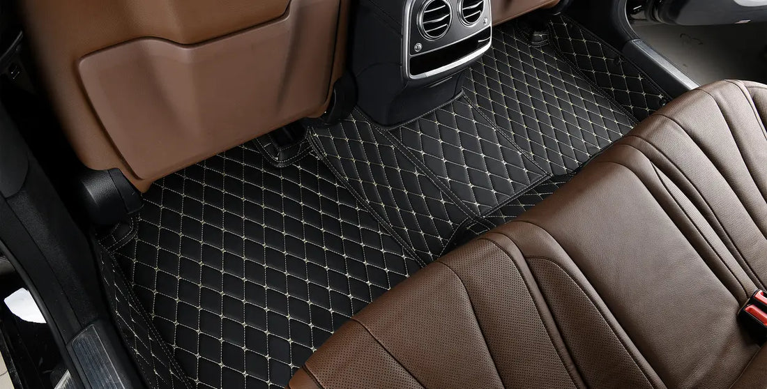 view of beautiful black luxury floor mats installed in the back of a car, contrasted with brown leather interior